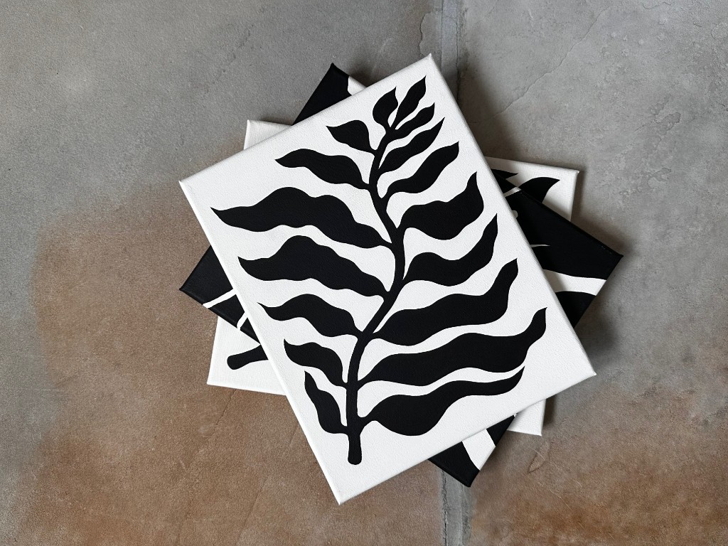 Fluid Nature canvases stacked on stone