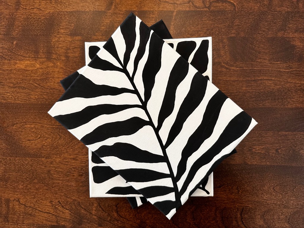 Noir Wilderness three canvases stacked on wood